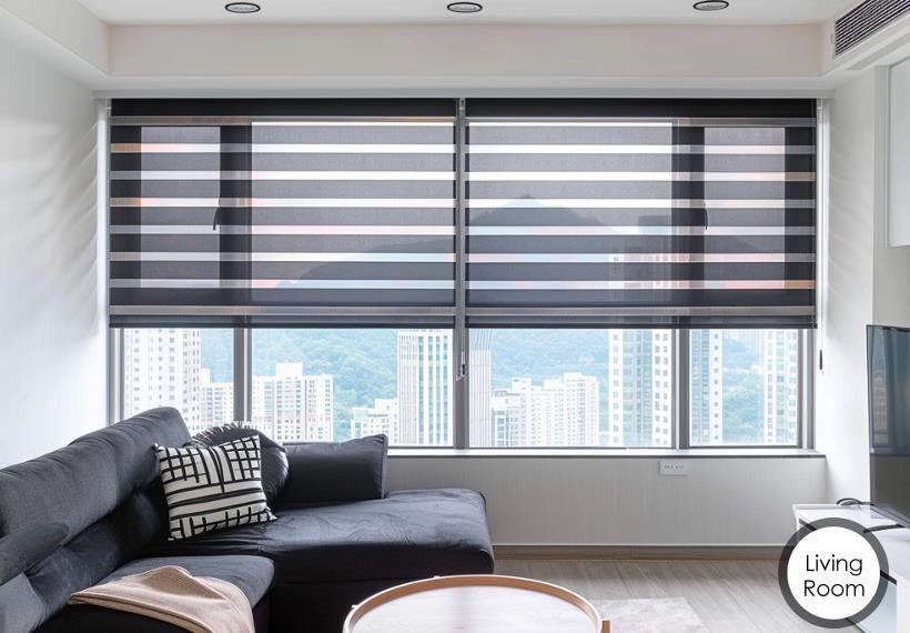 Modern living room with smart roller blinds and a city skyline view, controlled by Homynex